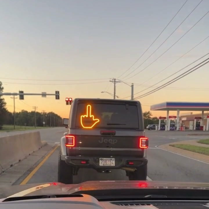 Amber LED hand gesture sign in a Jeep rear window